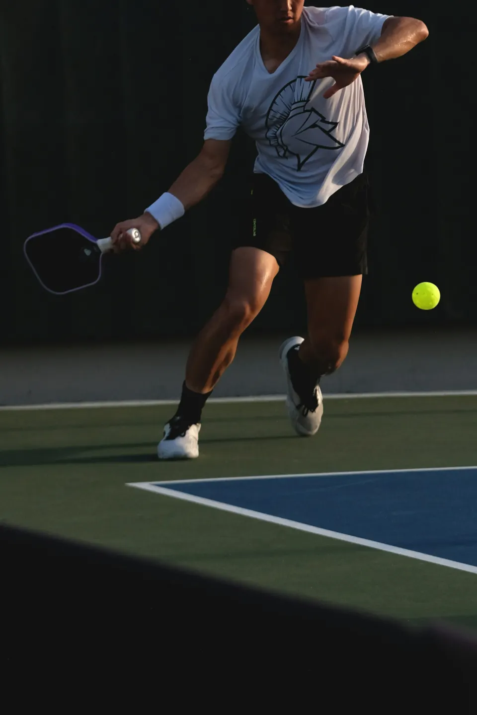 A player lunging for a forehand at golden hour